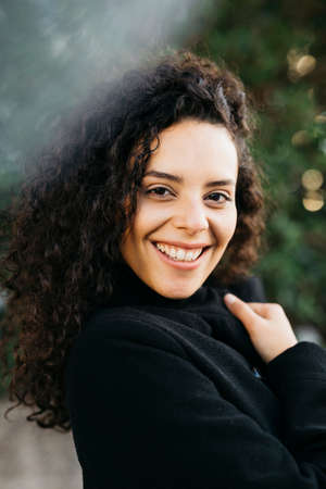 Portrait of a young latin american woman outdoorsの写真素材