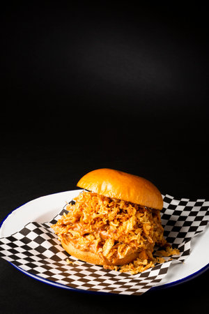 Pulled chicken burger over a black backgroundの写真素材