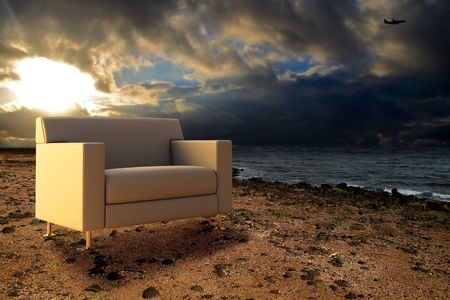 Comfortable seat on ocean coast under pectacular skyの写真素材