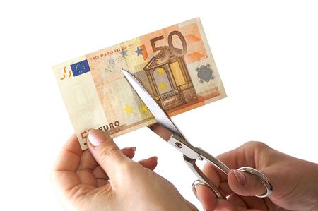 The female hand cuts the banknote with scissors