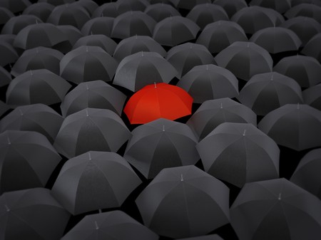 Many umbrellas black and only one redの写真素材