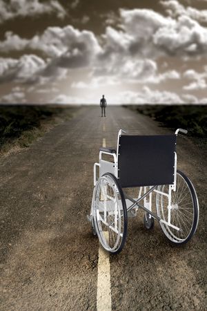 Man abandons the wheelchair and recommences to walkの写真素材