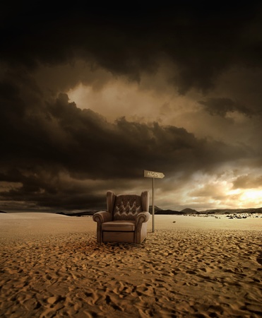 Old leather seat abandoned in the desert and arrow indicates the hopの写真素材