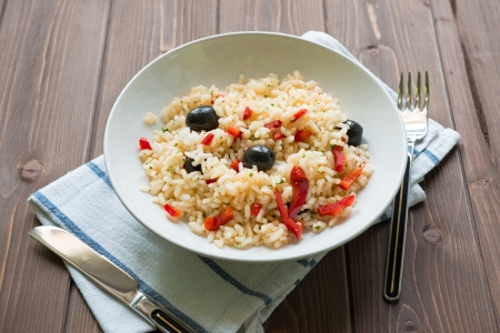 Rice with red capsicum and black olivesの写真素材