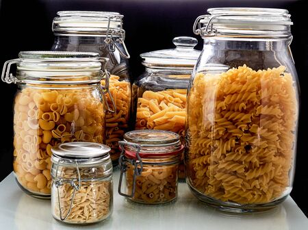 different types of pasta kept in glasses