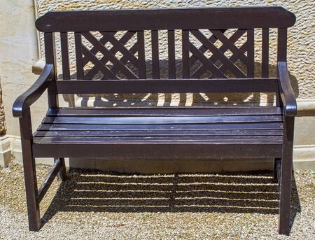 beautiful old brown park bench made of woodの写真素材