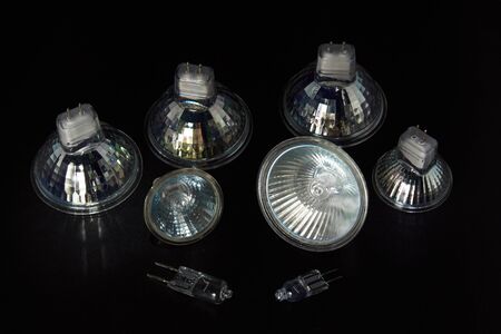 Different types of halogen lamps with and without reflector - close-up on black backgroundの写真素材