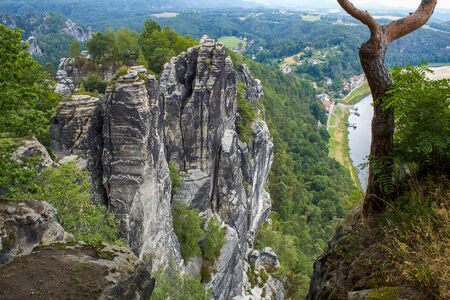 Sandstone cliffs in the 'Saxon Switzerland' with the Elbe in the background and view of the spa Rathenの写真素材