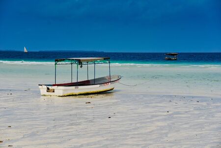 Boat in shallow water, Zanzibar, Tanzaniaの写真素材
