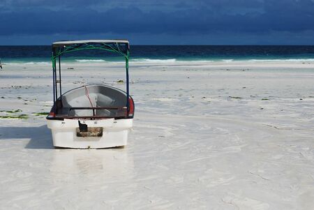 A boat on the beach on a sunny dayの写真素材