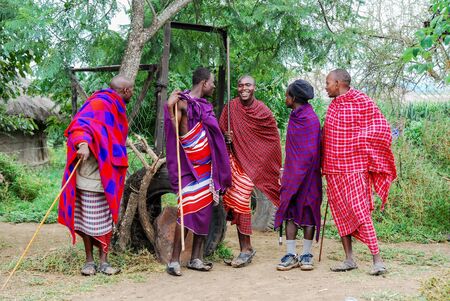 Various men in a rural village in Africa ready to jump wearing traditional clothes.のeditorial素材