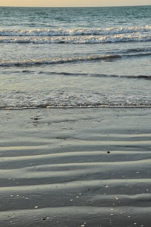 The beach at sunset with low tide.