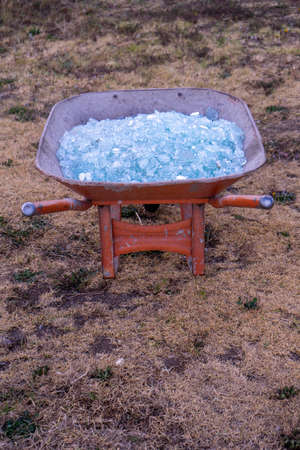 A close up of Shattered glass in a wheelbarrowの写真素材