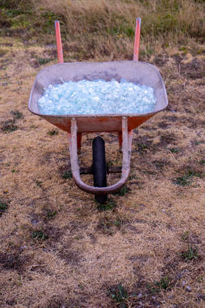 A close up of Shattered glass in a wheelbarrowの写真素材