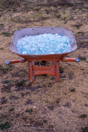 A close up of Shattered glass in a wheelbarrowの写真素材