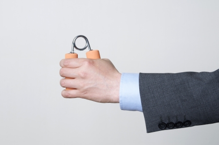Man in a suit demonstrating strengthの写真素材