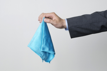 A man in a suit holding a cleaning clothの写真素材