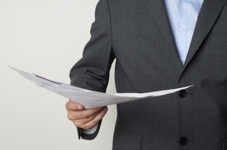 man in a suit holding some papersの写真素材