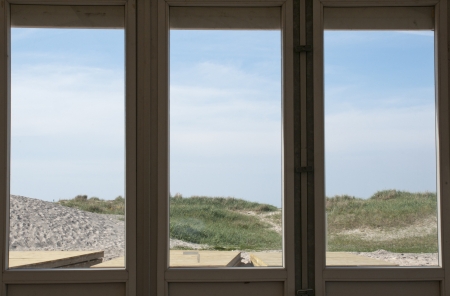 Beach view through glass windowの写真素材