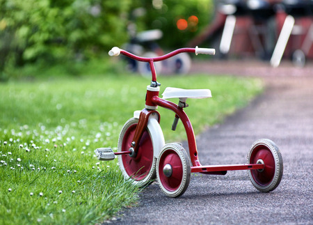 child tricycle left in the garden