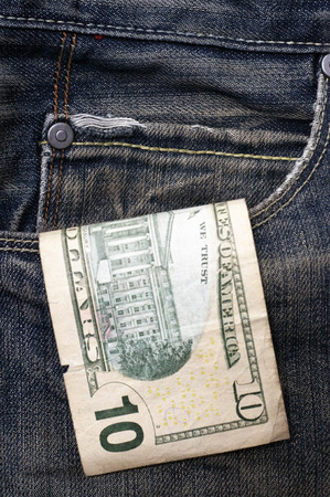 Ten dollar hanging out of a pocketの写真素材