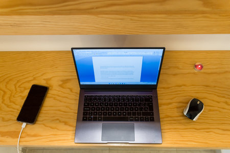 Laptop and smartphone on the shelf in the office, stock photo