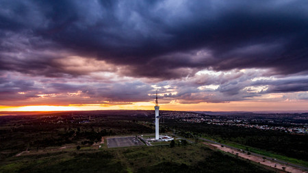 Digital tower in the Brazilian capital photographed by a drone in an aerial view in the late afternoon with an orange sun unveiling a beautiful twilight.のeditorial素材