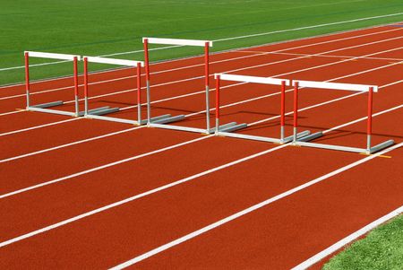 Unveven sized hurdles on race track for Justice, equality or fairness conceptの写真素材