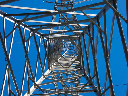 Transportation of electricity through copper cables that are supported by large metal towers. Electricity is generated in atomic power plants either by windmills or thermal power plants or by turbines moved by the force of water.の写真素材