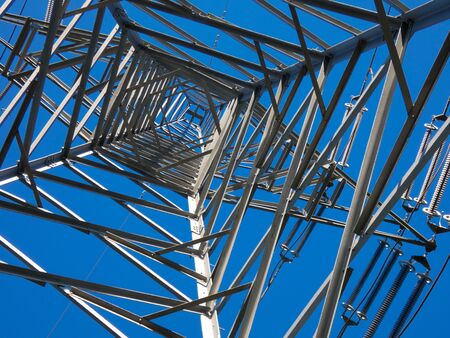 Transportation of electricity through copper cables that are supported by large metal towers. Electricity is generated in atomic power plants either by windmills or thermal power plants or by turbines moved by the force of water.の写真素材