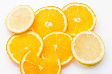 Slices of oranges and lemons, fruits full of juice with which juices are made, the sweetest orange than the lemon that is much more acidic, both full of vitamins C and very healthyの写真素材