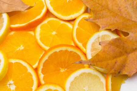 Slices of oranges and lemons, fruits full of juice with which juices are made, the sweetest orange than the lemon that is much more acidic, both full of vitamins C and very healthyの写真素材
