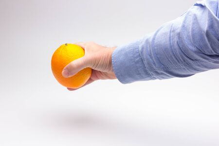 Orange is a fruit of a size that fits in the hand of an adult person, it is split in half to make a juice, rich in vitamins and low in calories; very refreshingの写真素材