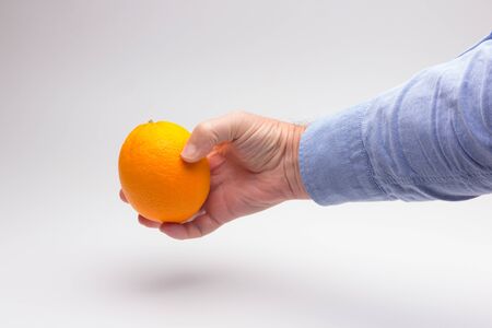 Orange is a fruit of a size that fits in the hand of an adult person, it is split in half to make a juice, rich in vitamins and low in calories; very refreshingの写真素材