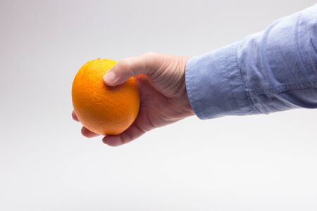 Orange is a fruit of a size that fits in the hand of an adult person, it is split in half to make a juice, rich in vitamins and low in calories; very refreshingの写真素材