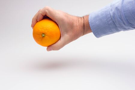 Orange is a fruit of a size that fits in the hand of an adult person, it is split in half to make a juice, rich in vitamins and low in calories; very refreshingの写真素材