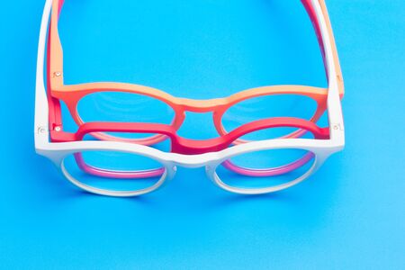 Glasses and lenses graduated on a plain background, with graduated glasses to be able to see either...