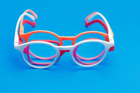 Glasses and lenses graduated on a plain background, with graduated glasses to be able to see either from far or near or to enlarge the size of the letters.の写真素材