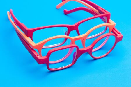 Glasses and lenses graduated on a plain background, with graduated glasses to be able to see either from far or near or to enlarge the size of the letters.の写真素材
