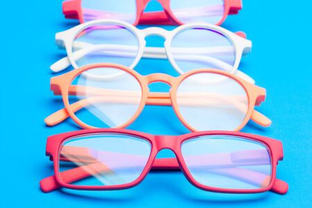 Glasses and lenses graduated on a plain background, with graduated glasses to be able to see either...