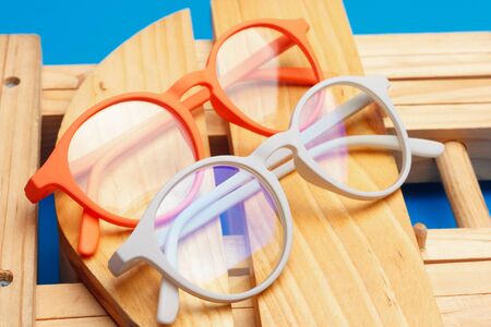 Glasses and lenses graduated on a plain background, with graduated glasses to be able to see either from far or near or to enlarge the size of the letters.の写真素材
