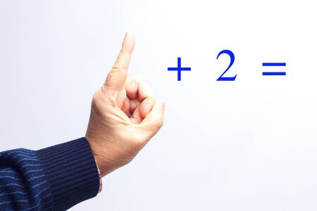 Add with the fingers of the hands; learn to add in school; numbers written with figures and numbers with the fingers.の写真素材