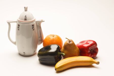 Vintage coffee maker with orange fruits, banana and red and green pepper. Classic minimalist still life with light, light and shadow proofs.の写真素材