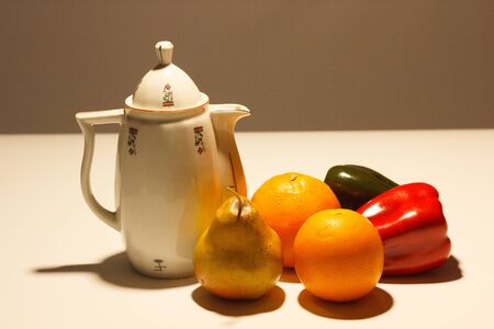 Vintage coffee maker with orange fruits, banana and red and green pepper. Classic minimalist still life with light, light and shadow proofs.の素材 [FY310138446042]