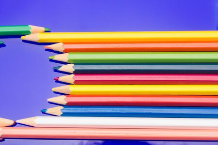 Colored pencils with a sharp point ready to draw and paint drawings; color with colors; color range from white to black through the entire color range, yellow, pink, green, blue, red, brown.の写真素材