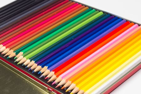 Colored pencils with a sharp point ready to draw and paint drawings; color with colors; color range from white to black through the entire color range, yellow, pink, green, blue, red, brown.の写真素材