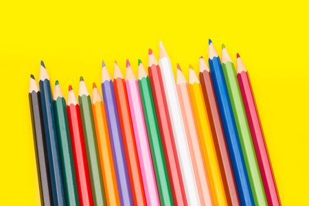 Colored pencils with a sharp point ready to draw and paint drawings; color with colors; color range from white to black through the entire color range, yellow, pink, green, blue, red, brown.の写真素材
