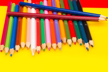 Colored pencils with a sharp point ready to draw and paint drawings; color with colors; color range from white to black through the entire color range, yellow, pink, green, blue, red, brown.の写真素材
