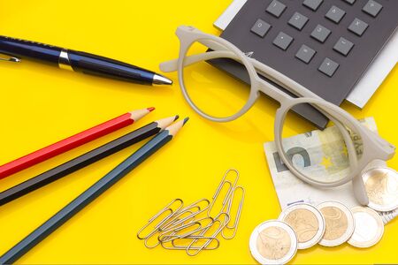 Papers, glasses and calculator to make calculations of the invoices we receive, to make graphs and statistics of our expenses or benefits. scientific calculator used by science studentsの写真素材