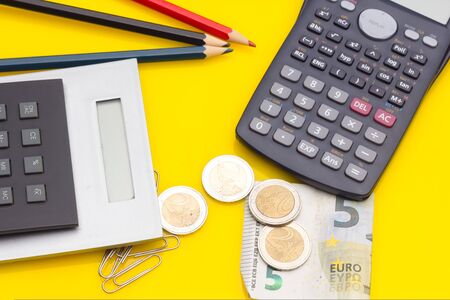 Papers, glasses and calculator to make calculations of the invoices we receive, to make graphs and statistics of our expenses or benefits. scientific calculator used by science studentsの写真素材